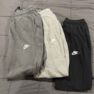 Set of 3 Nike Mens sportswear club fleece joggers - Gray, Light Gray, and Black